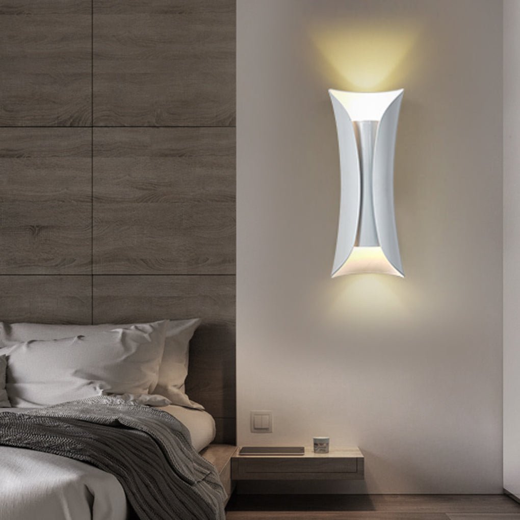 Modern indoor up down wall lights mounted on bedroom wall with minimalist interior design.