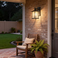 Modern lantern outdoor wall light illuminating a cozy patio seating area with warm ambient lighting.