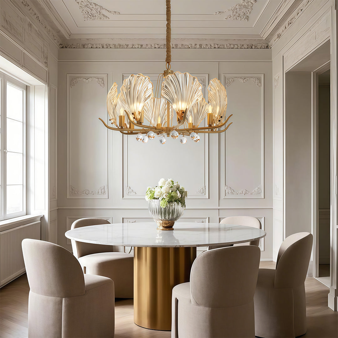 Modern large chandeliers enhancing elegant white dining room with paneled walls and round table
