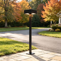 Modern LED path lights illuminating residential driveway landscaping with sleek black outdoor bollard design.