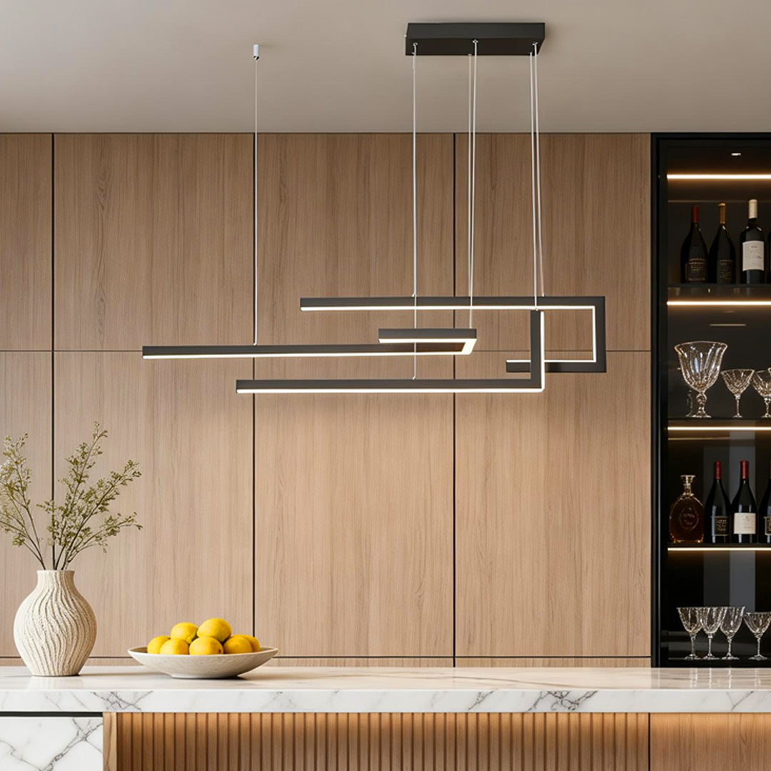 Modern linear LED chandelier providing focused light above a wooden kitchen counter.