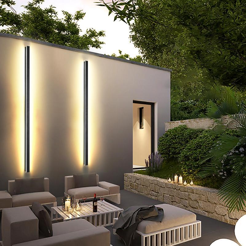 Modern linear outdoor wall sconce with warm light, installed on dark exterior wall for contemporary outdoor ambiance.