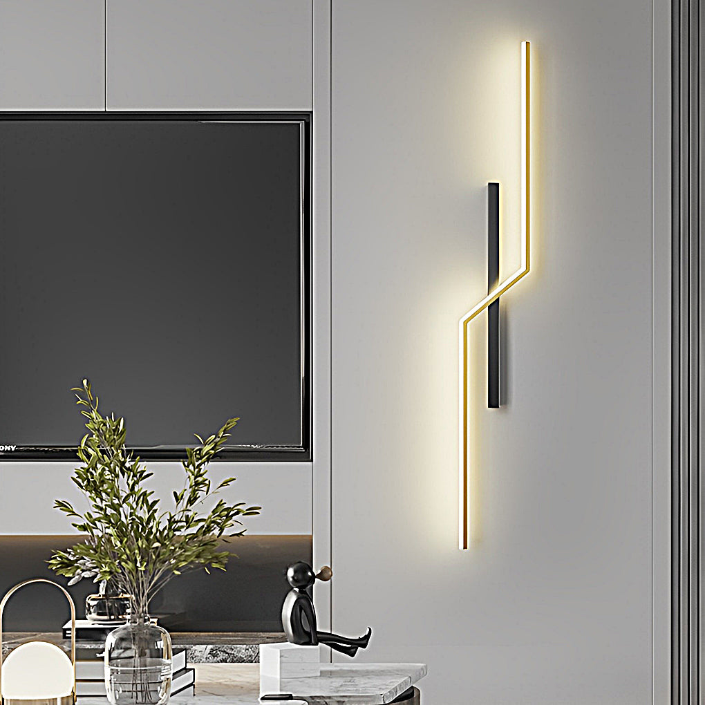 Modern linear wall sconce with geometric shape mounted near TV wall in contemporary interior space.