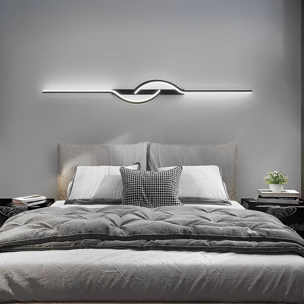 Close up of modern linear wall sconce showing curved LED light detail.