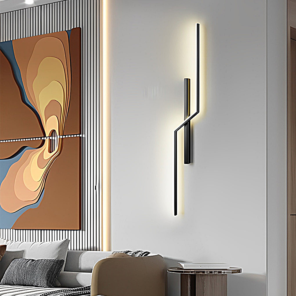 Vertical modern linear wall sconce with sculptural design used as accent lighting in contemporary living room.