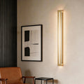 Modern minimalist gold and long black wall sconces for living room decor.