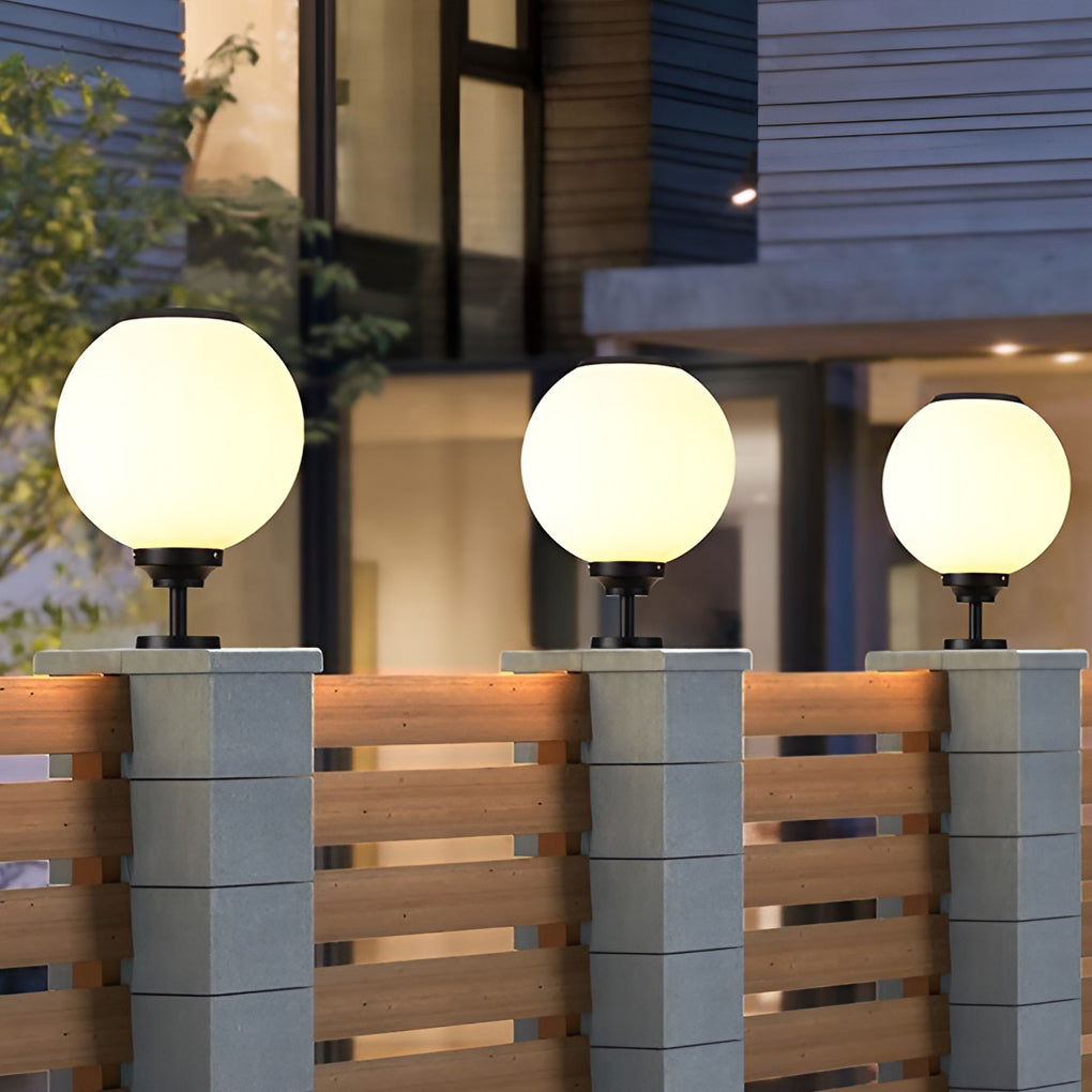Modern outdoor gate pillar light with a minimalist spherical design, mounted on a stone pillar for stylish outdoor ambiance.