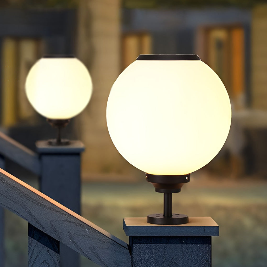 Modern outdoor gate pillar light with a spherical design, installed on a stone pillar for elegant outdoor lighting.