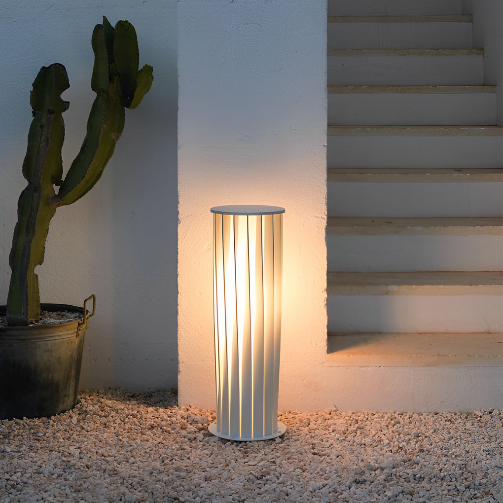 Minimalist modern outdoor lanterns placed near exterior stairs providing vertical accent lighting.