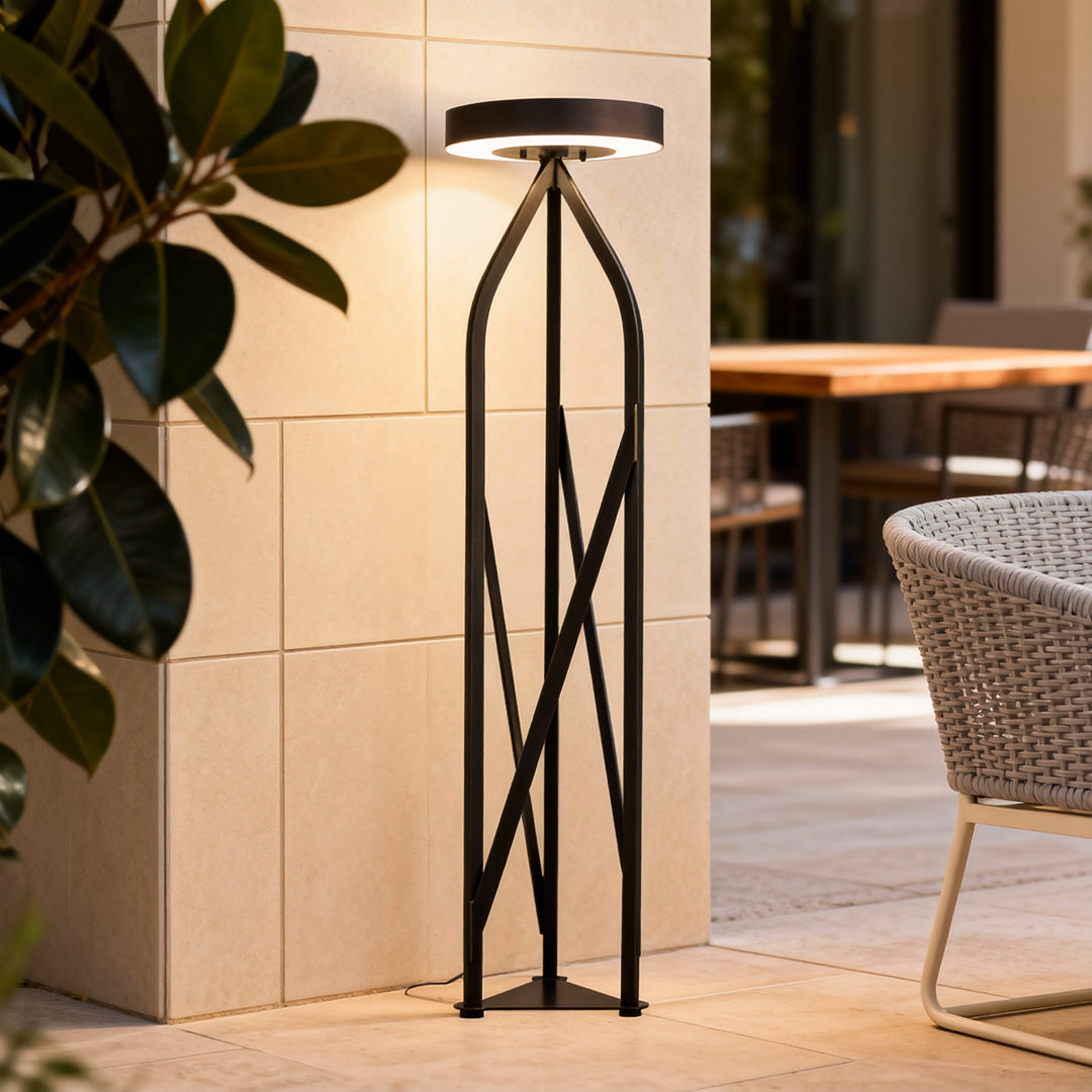 Modern outdoor patio floor lamps adding ambiance to a cozy patio area with potted plants and seating.