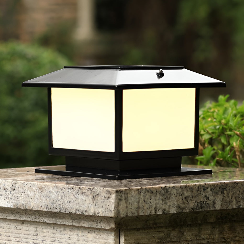 Close-up of a modern outdoor pillar light's corner, highlighting its sleek black frame and frosted glass panels.