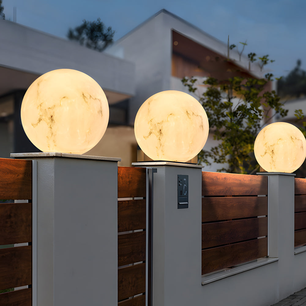 Modern outdoor pillar lights installed along stone steps, creating a welcoming pathway with elegant lighting.