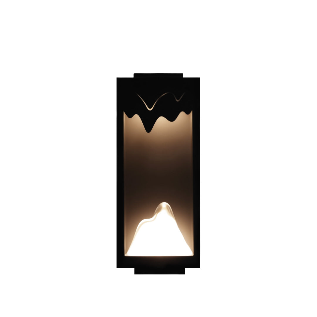 Modern outdoor wall lighting ideas displaying rectangular sconce with decorative top edge and ambient illumination pattern