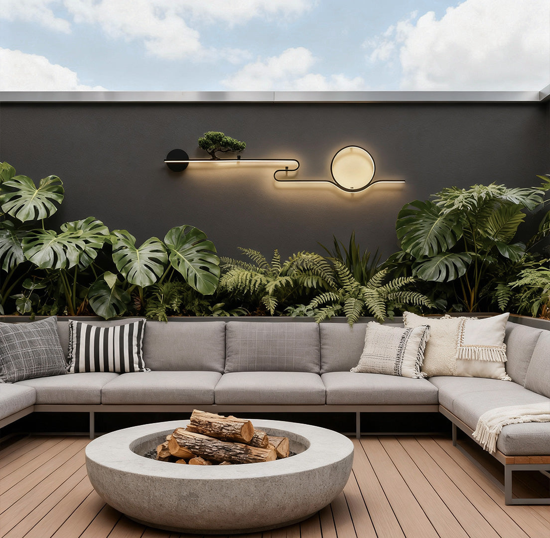 Modern outdoor wall lights with circular LED design mounted on a concrete garden wall daytime.