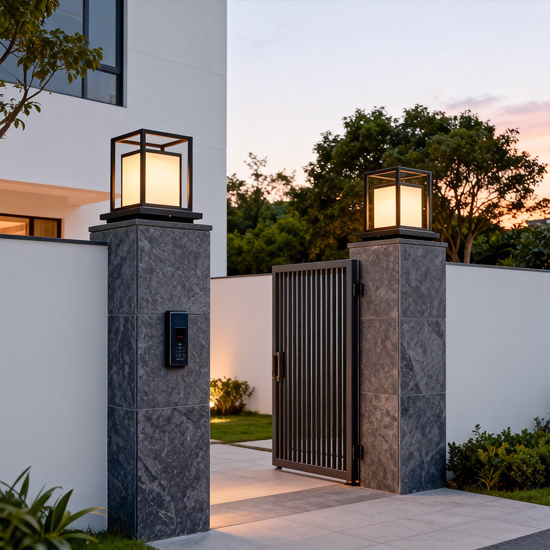 Modern outdoor wall pillar lights mounted on entrance gate columns with elegant warm illumination.