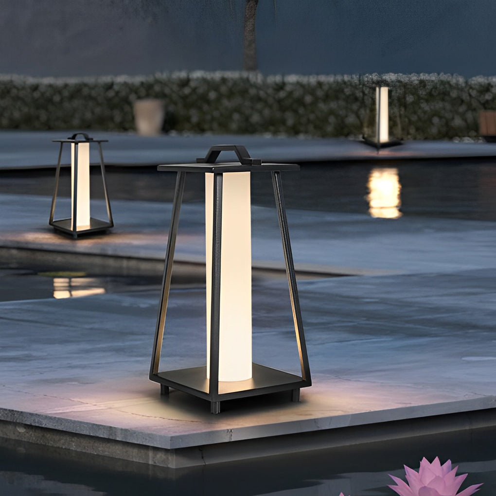 Modern portable outdoor lantern illuminating a poolside area with reflections on water at dusk.