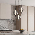 Sleek modern silver pendant light trio with smoked glass globes above a luxury marble kitchen.