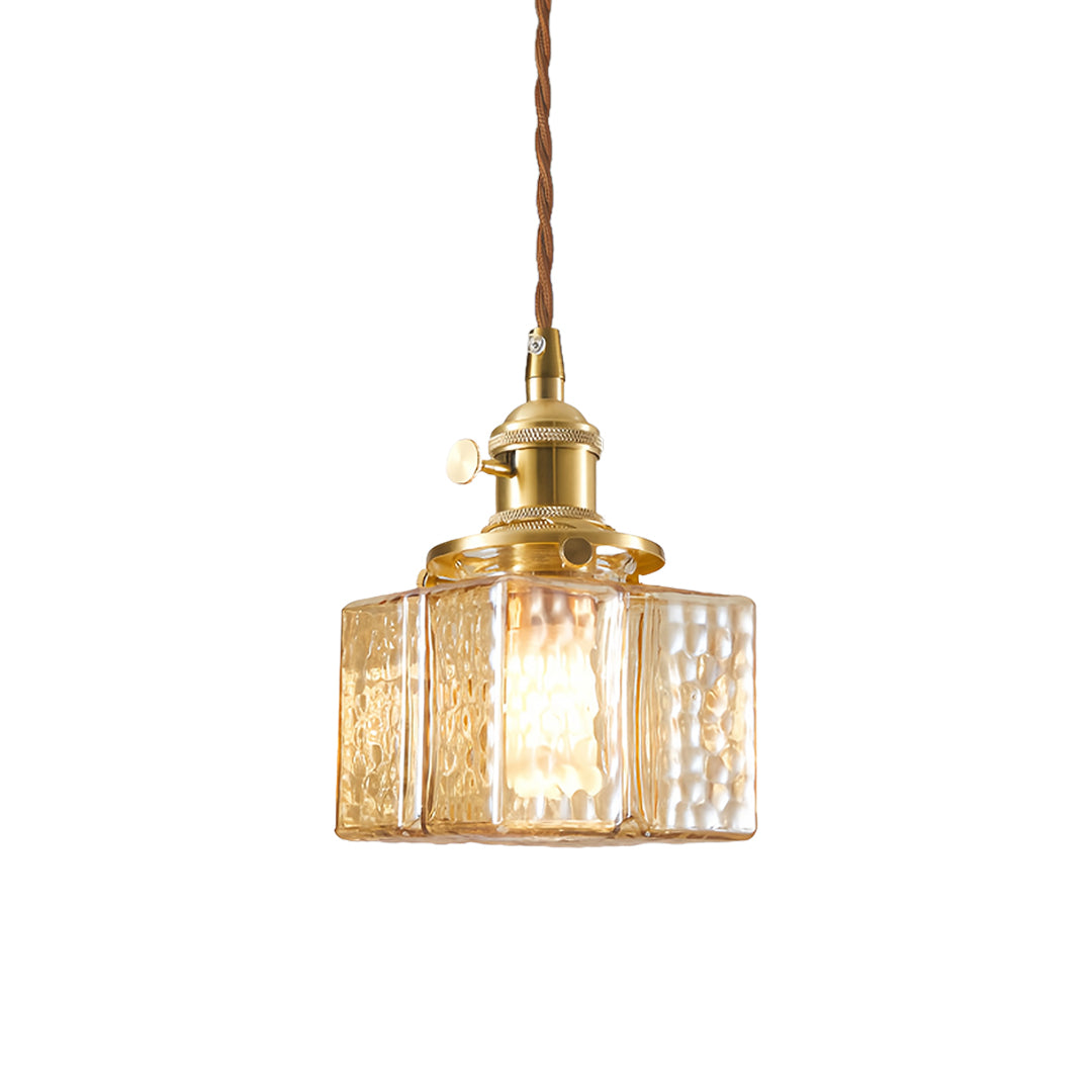 Modern square glass pendant light featuring ribbed glass design and gold hardware for contemporary decor.