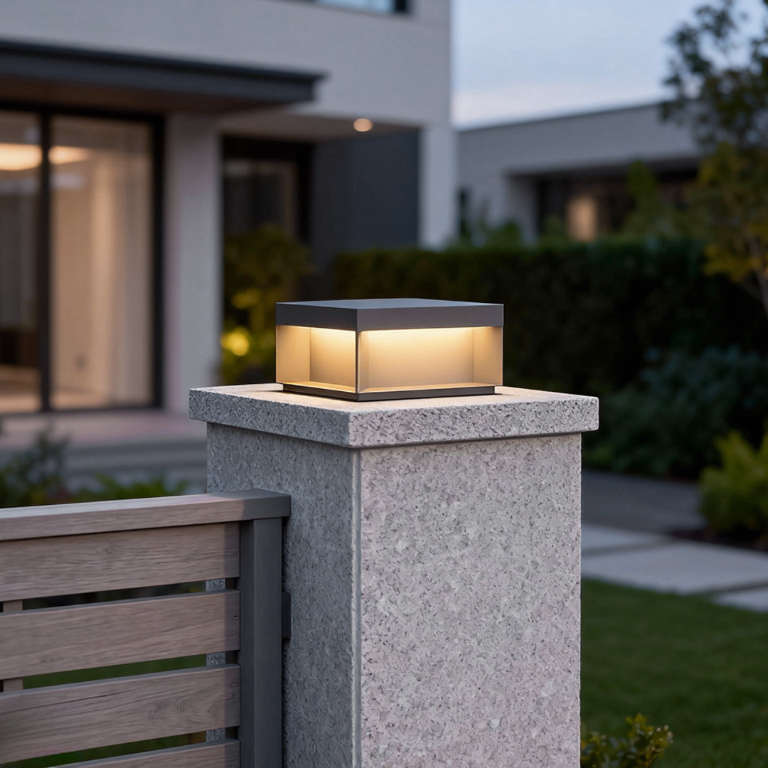 Modern square solar deck lights mounted on stone pillar at residential entrance.