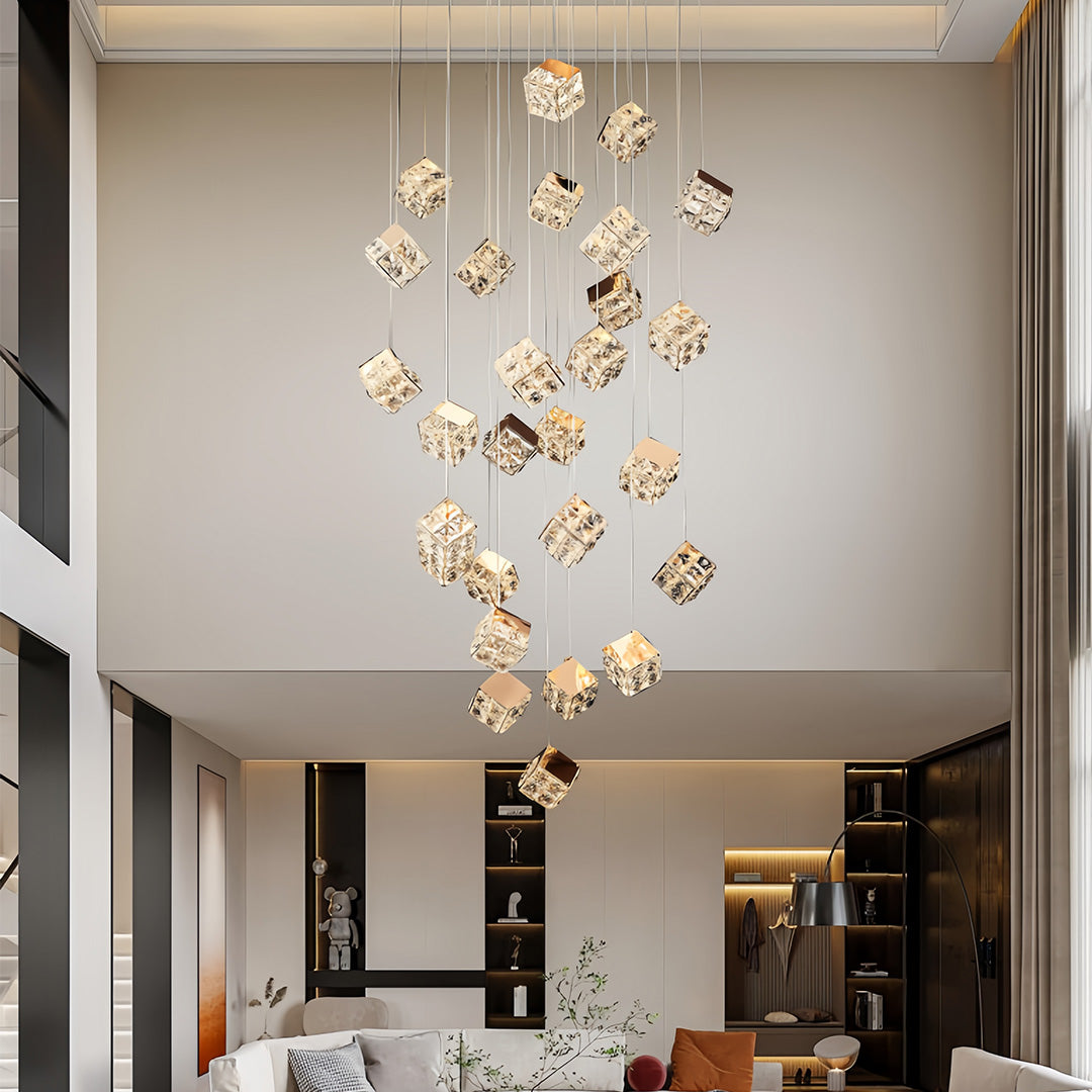 Large modern stairs chandelier hanging above open staircase in double-height living room.