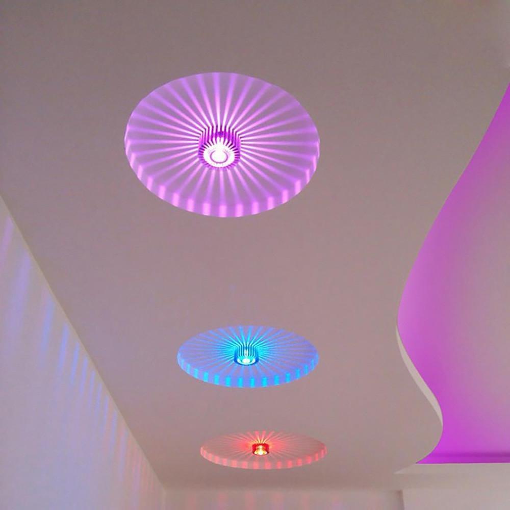 Modern sunburst ceiling fixture casting colorful light in a chic modern ceiling.