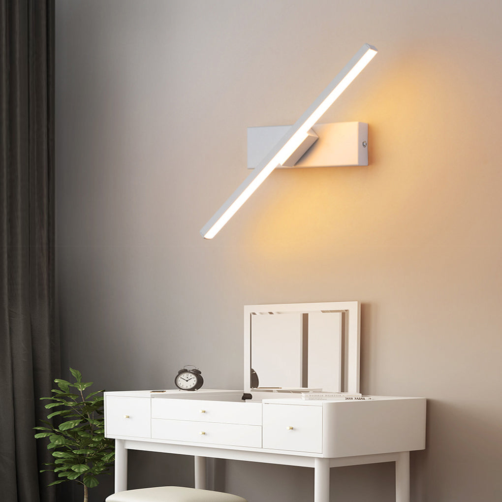 Modern swivel wall light in black, providing focused illumination for a white dressing table in a stylish bedroom.