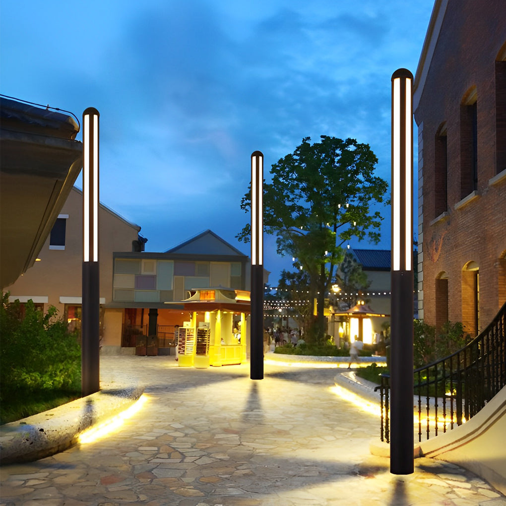 Tall garden bollard light with modern design beside contemporary house entrance.