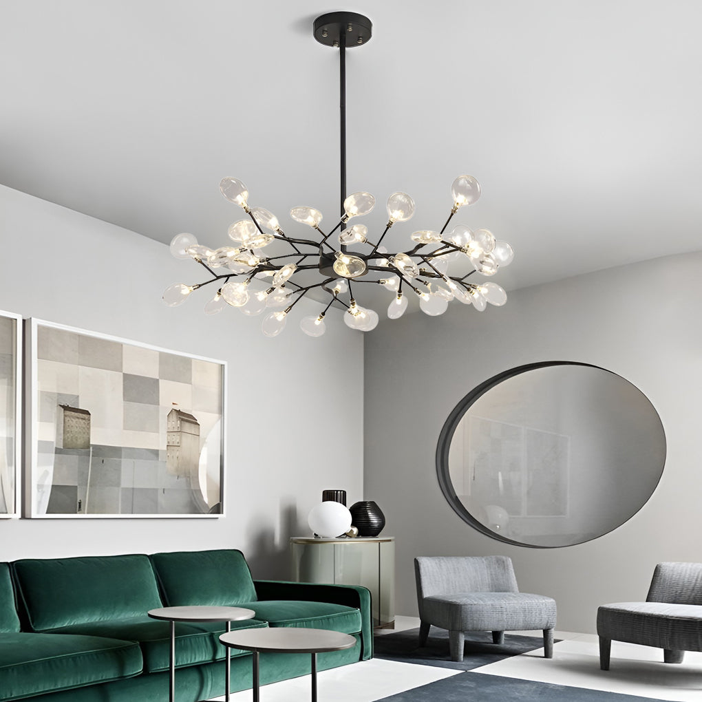 Modern tree branch chandelier illuminating a modern living room with minimalist decor.