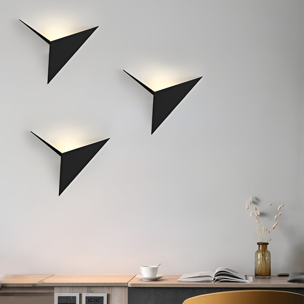 Modern triangle wall sconce providing soft illumination in a stylish hallway.