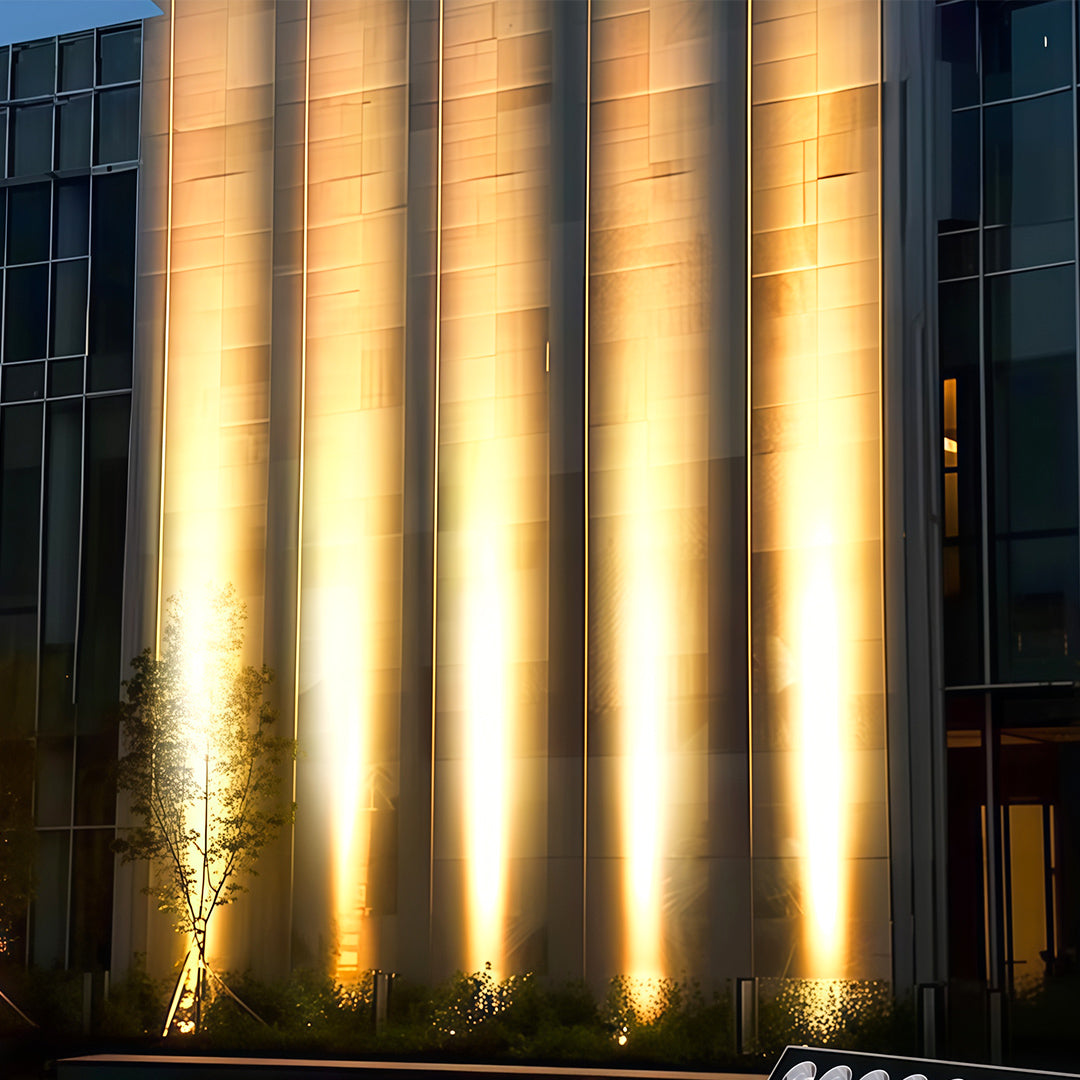 Modern villa exterior highlighted by warm square wall wash light.