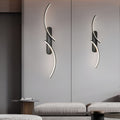 Modern wave wall sconce enhancing a contemporary bedroom with sleek design.