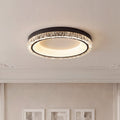 Modern white flush mount ceiling light with a black trim and sparkling crystal textured ring.