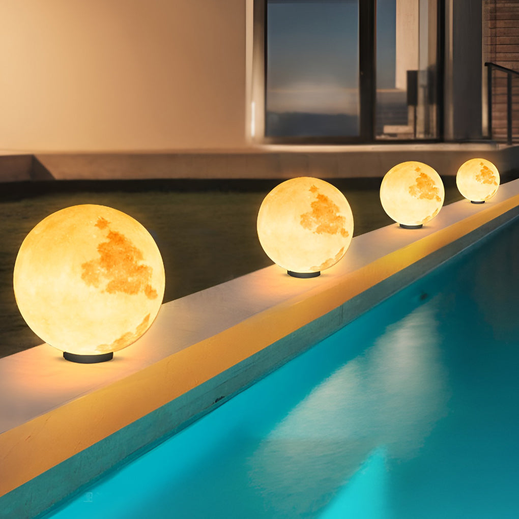 Moon pillar lights with moon design, mounted on poolside wall for ambient lighting.