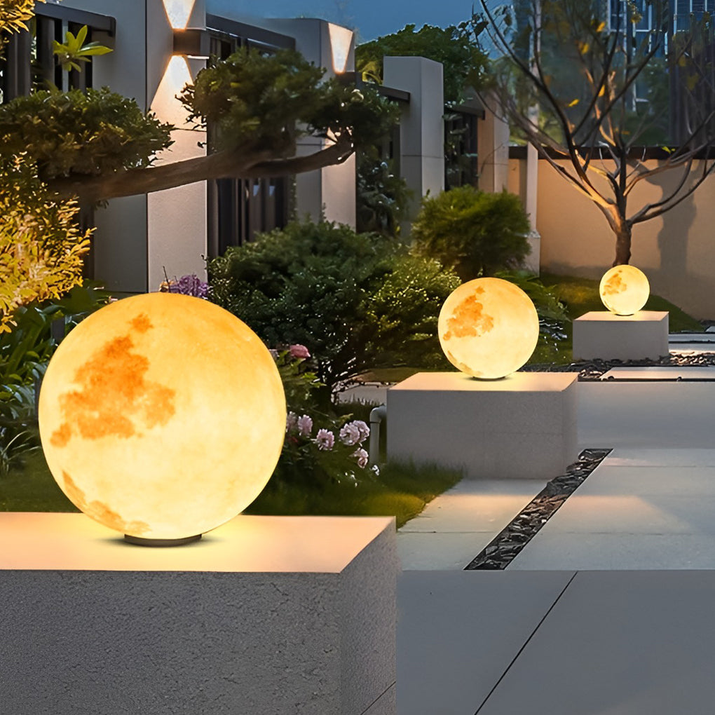 Moon pillar lights with realistic moon surface, placed on stone pillars in garden.