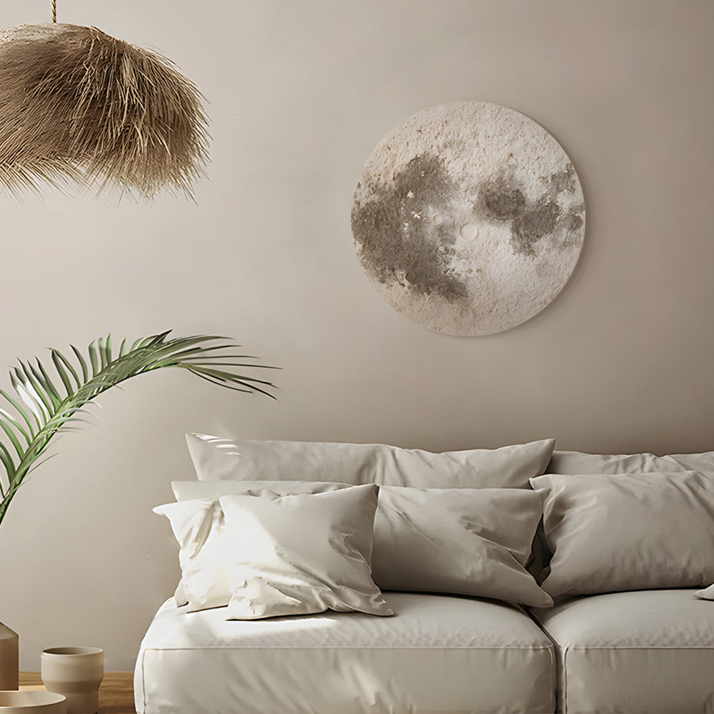 Moon wall lamp illuminating a stylish seating area with warm light.