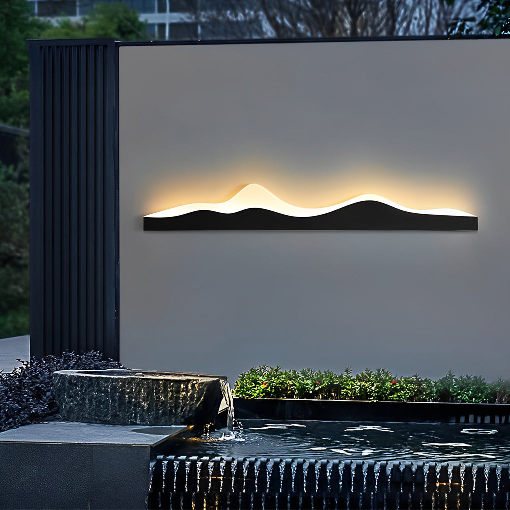 Mountain LED wall light mounted on a gray wall, enhancing the modern outdoor decor.