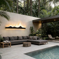 Mountain LED wall light illuminating a modern outdoor seating area beside a pool at dusk.