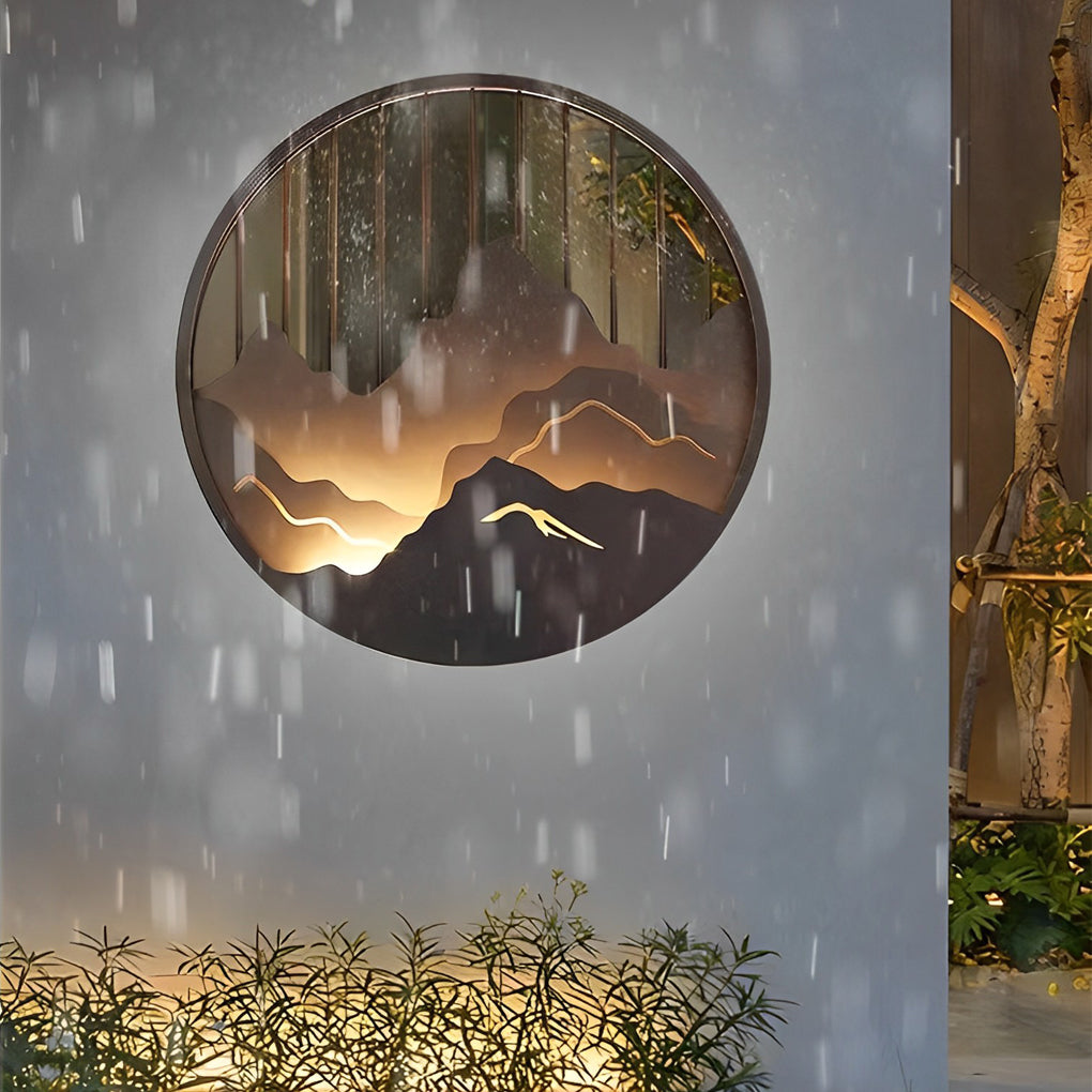 Mountain LED wall light displayed at night with soft backlit mountain contours.