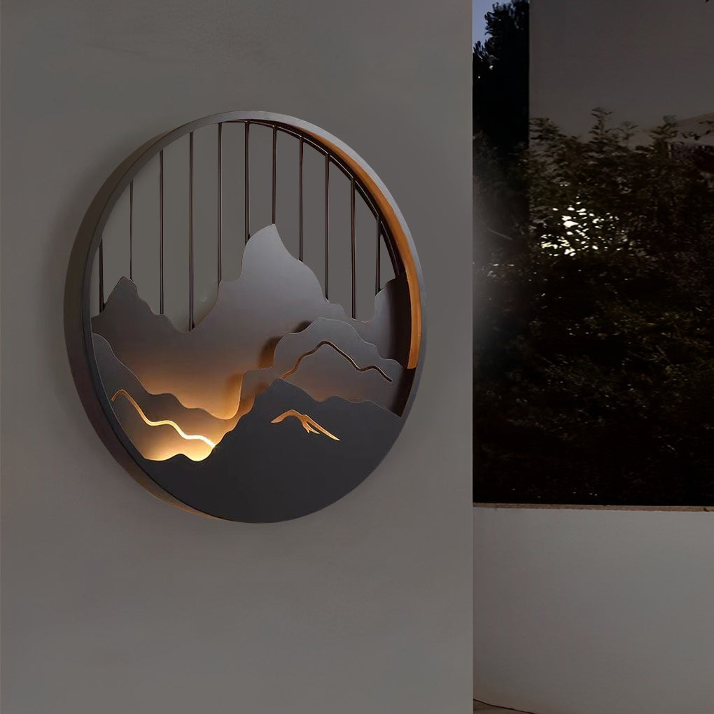 Mountain LED wall light mounted on white wall emphasizing circular art form.