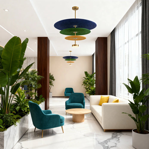Multiple cascading blue and green 3 tier chandelier lights enhancing the sophisticated ambiance of a contemporary hotel lobby.