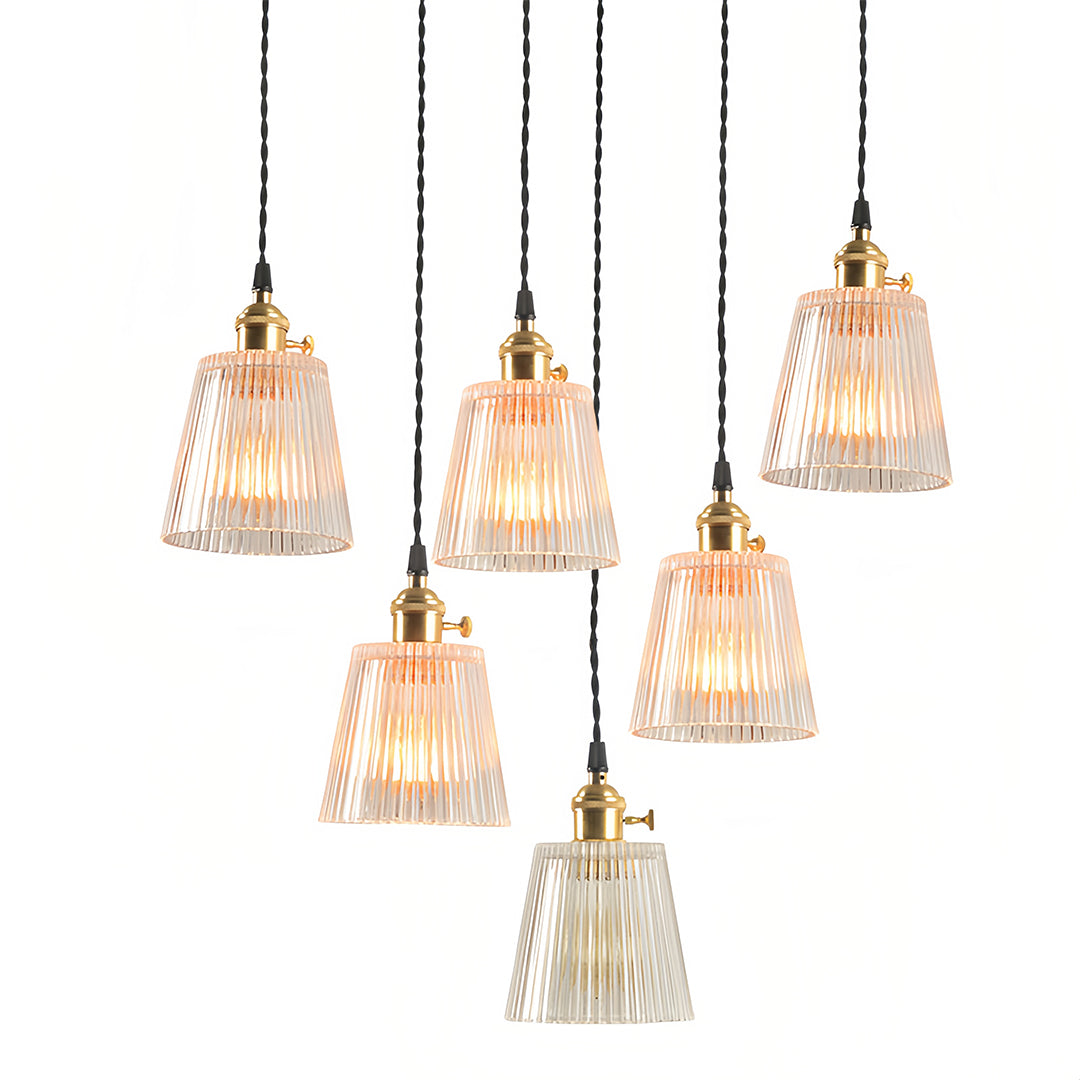 Multiple clear glass pendant lights arranged in cluster for dramatic dining room illumination