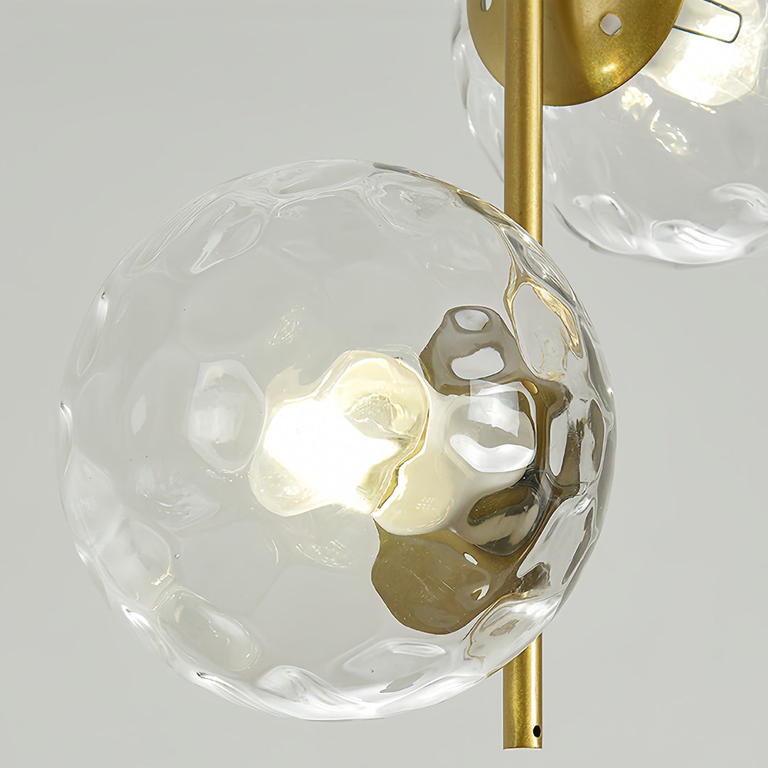 Multiple glass hanging pendant lights in modern bathroom with navy walls and contemporary interior styling