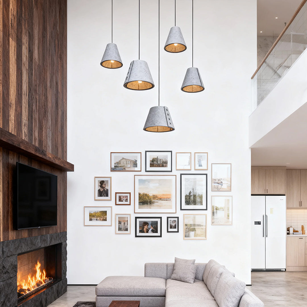 multiple grey hanging pendant lights at varying heights in a modern vaulted ceiling living room