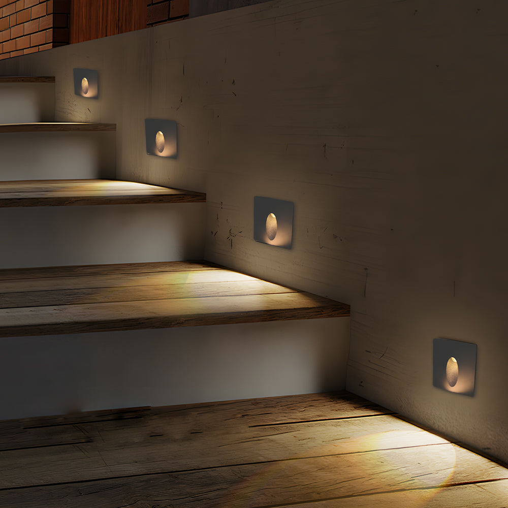 Multiple LED step lights creating dramatic stair illumination with warm ambient lighting for modern architectural design