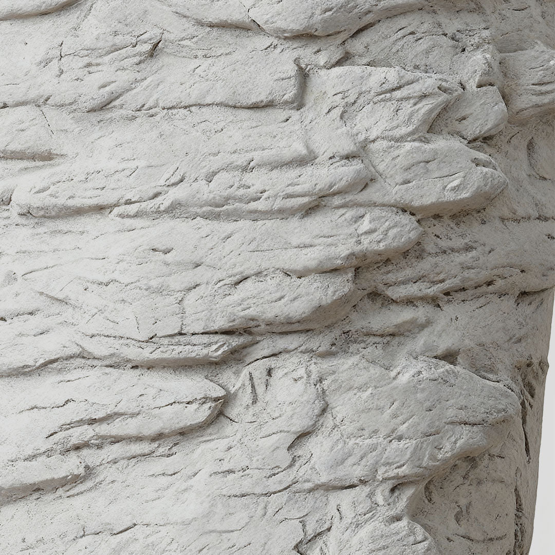 Night wall light providing subtle glow in bedroom with abstract geometric stone-like design