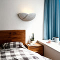 Pair of night wall lights with flared ceramic design flanking modern bathroom vanity mirror