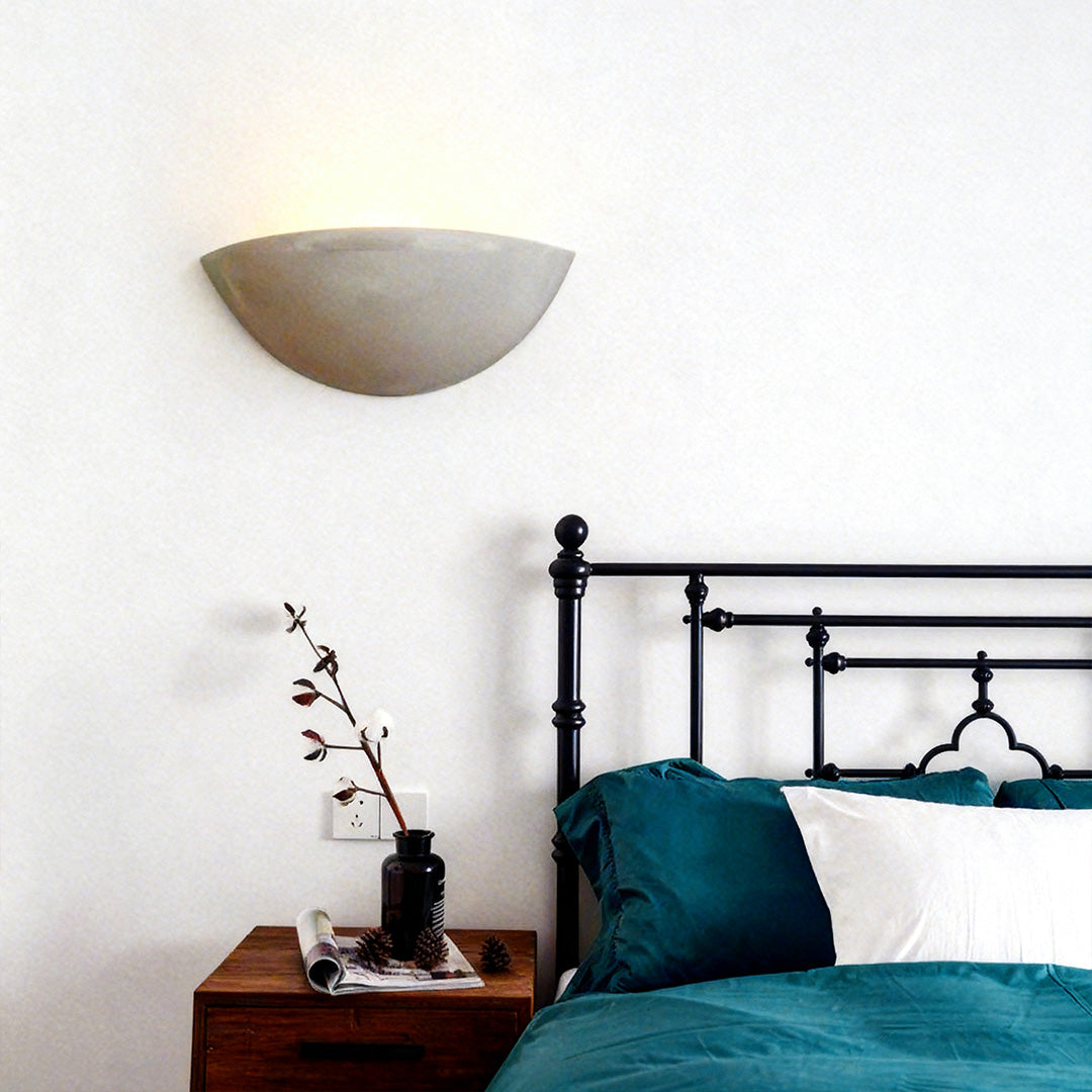 Minimalist night wall light with cement body and up lighting, providing warm, stylish illumination for modern bedrooms and hallways.