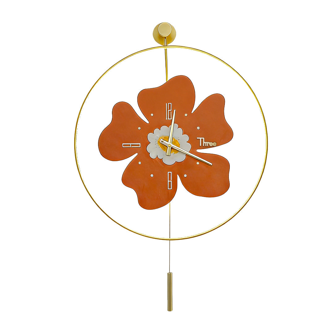 Orange floral wall clock with light with gold pendulum on a white background.