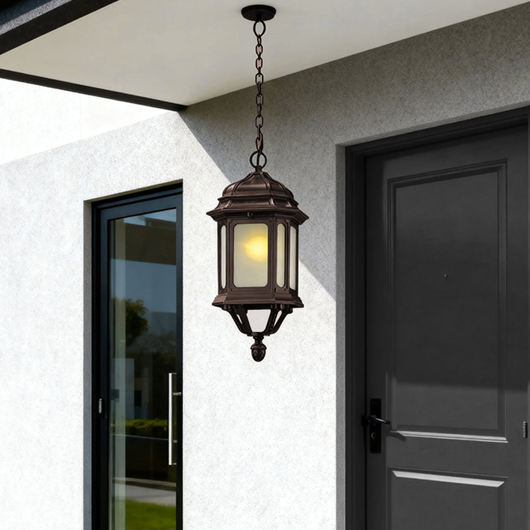 Ornate bollard LED light mounted near modern grey front door on contemporary home exterior
