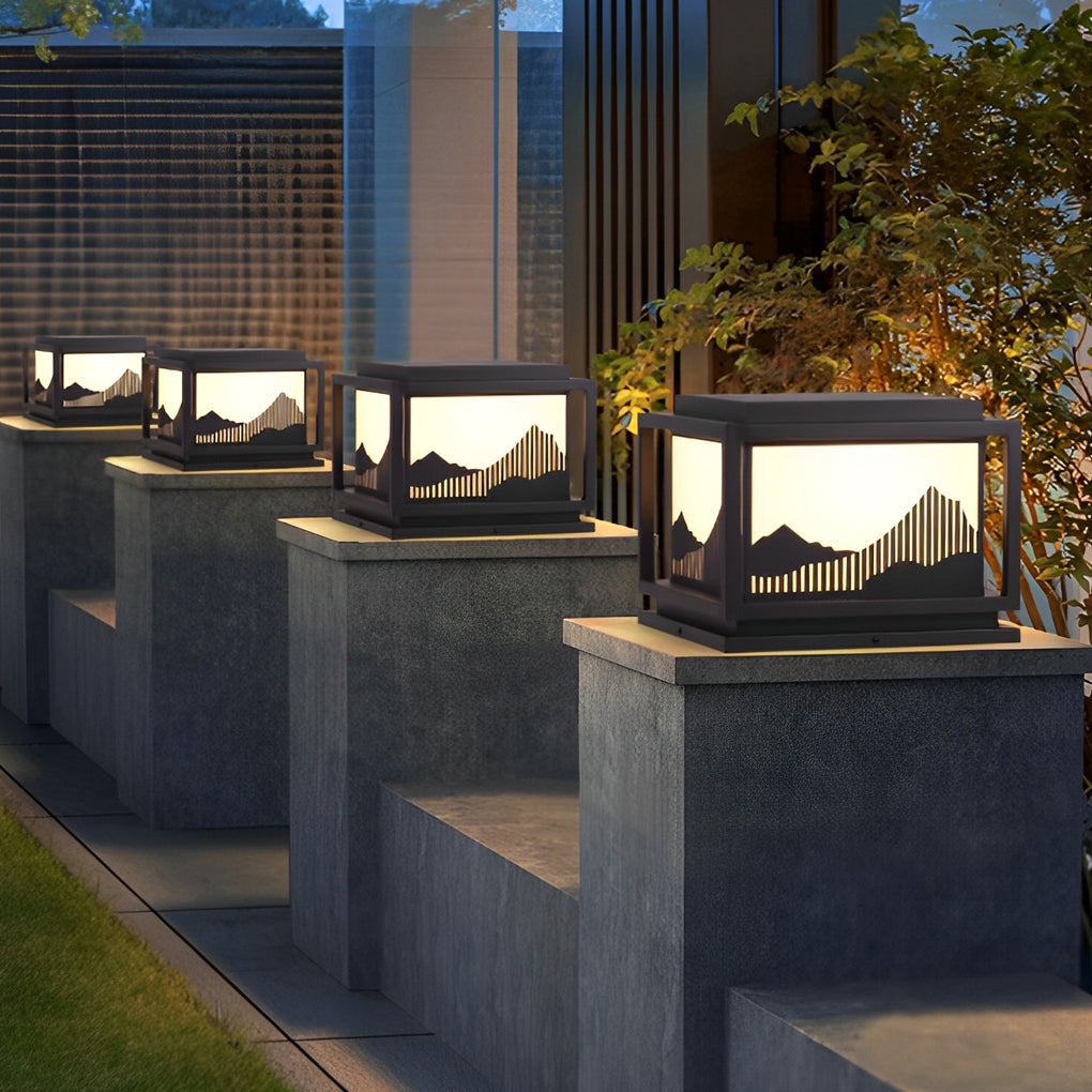 Outdoor brick pillar lights illuminating a minimalist outdoor garden with focused glow.